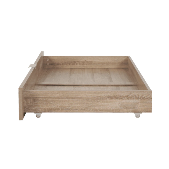 Side view of the underbed storage drawer in oak with castor wheels and smooth detailing, designed for easy access under cot beds