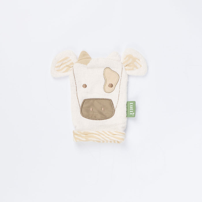 Close-up of Clemi the Cow wash mitt showing soft terry texture, beige embroidered cow face, and patterned inner fabric