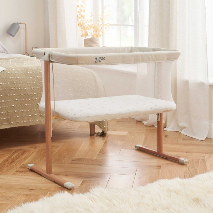 A ZiZee Breathable Rocking Crib with Scandinavian Walnut and Ecru finish, featuring an all-around mesh and wheels for mobility.